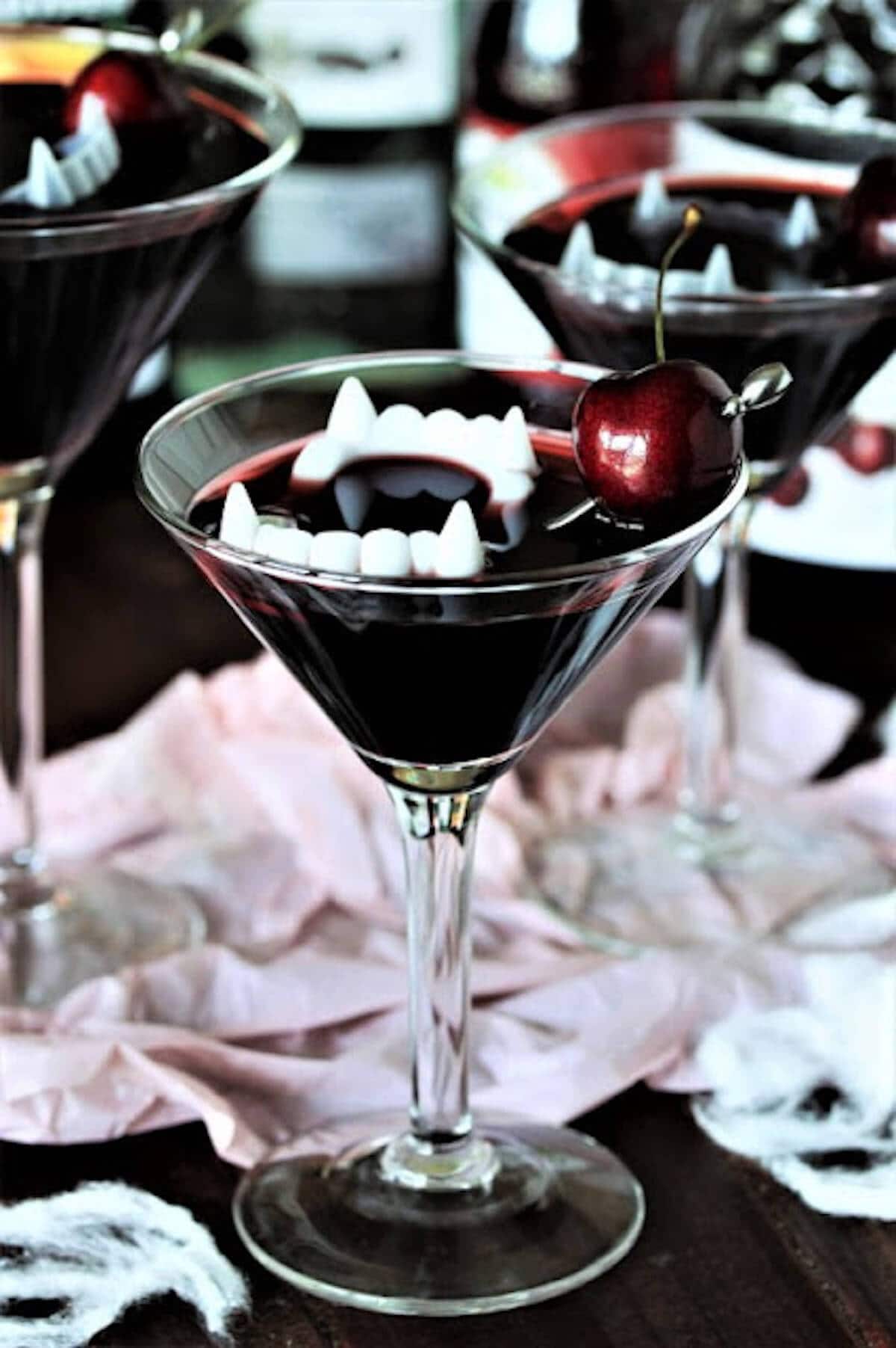 Martini topped with vampire teeth for garnish.