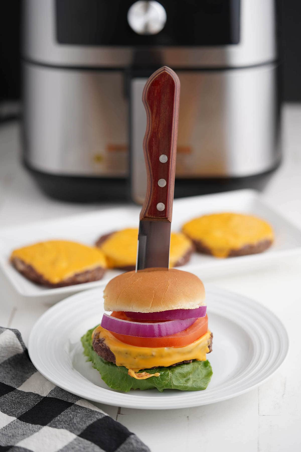 Grilled cheeseburger on plate.