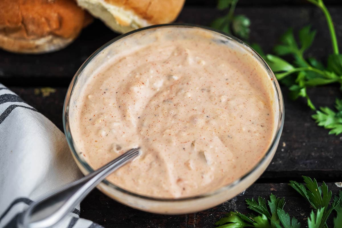 A bowl of the best burger sauce with a spoon.
