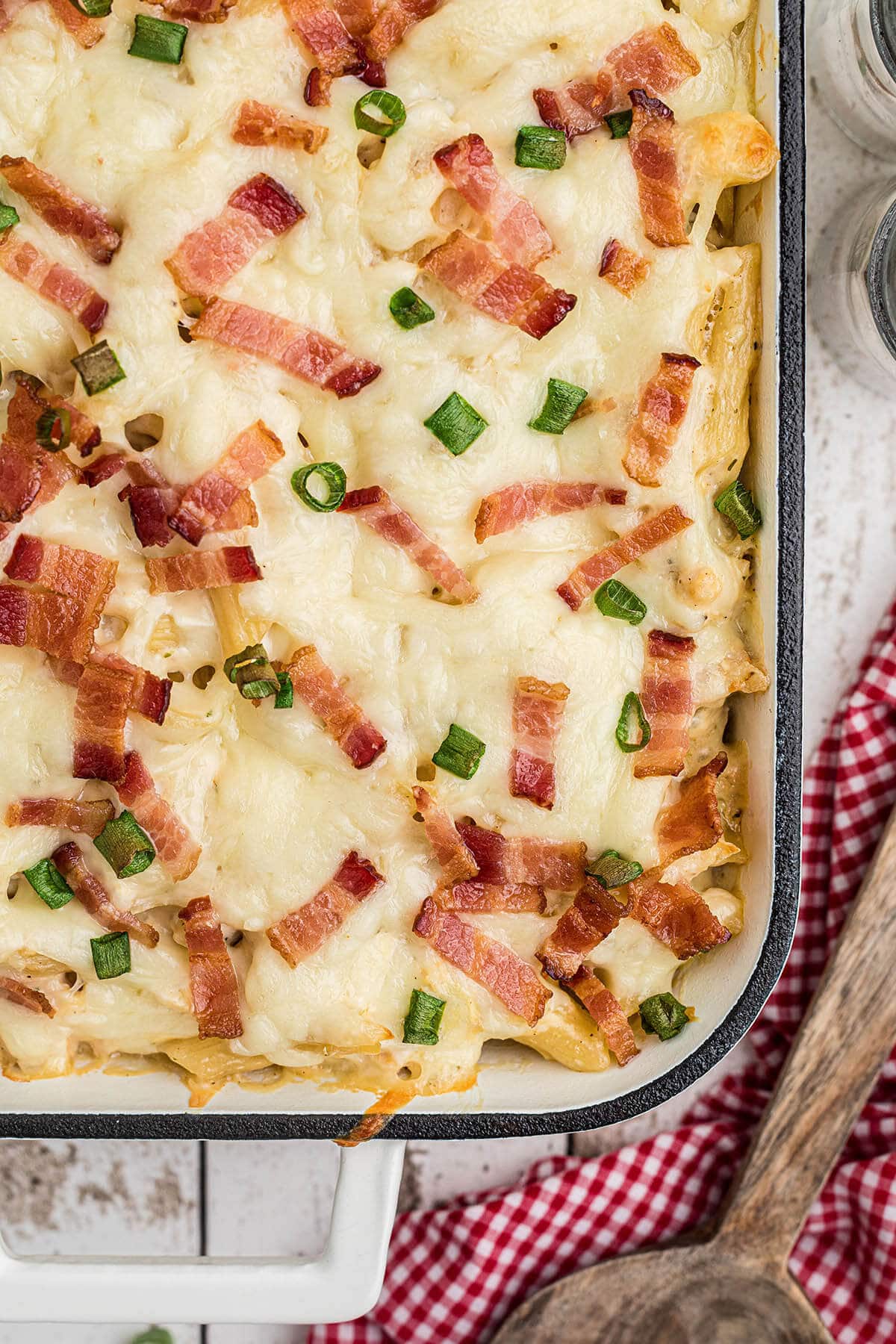 Chicken bacon ranch casserole in baking dish, with spoon.