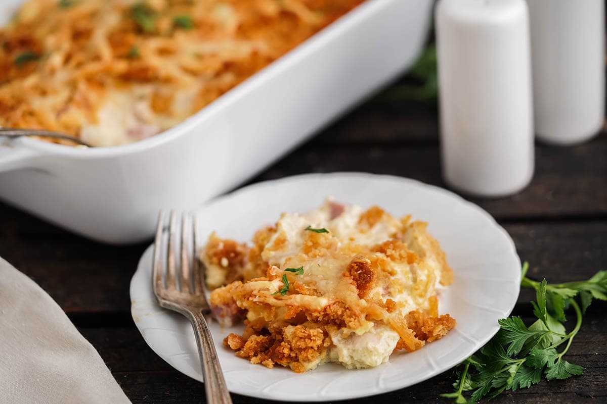 Chicken casserole with crispy cracker topping on plate with fork.