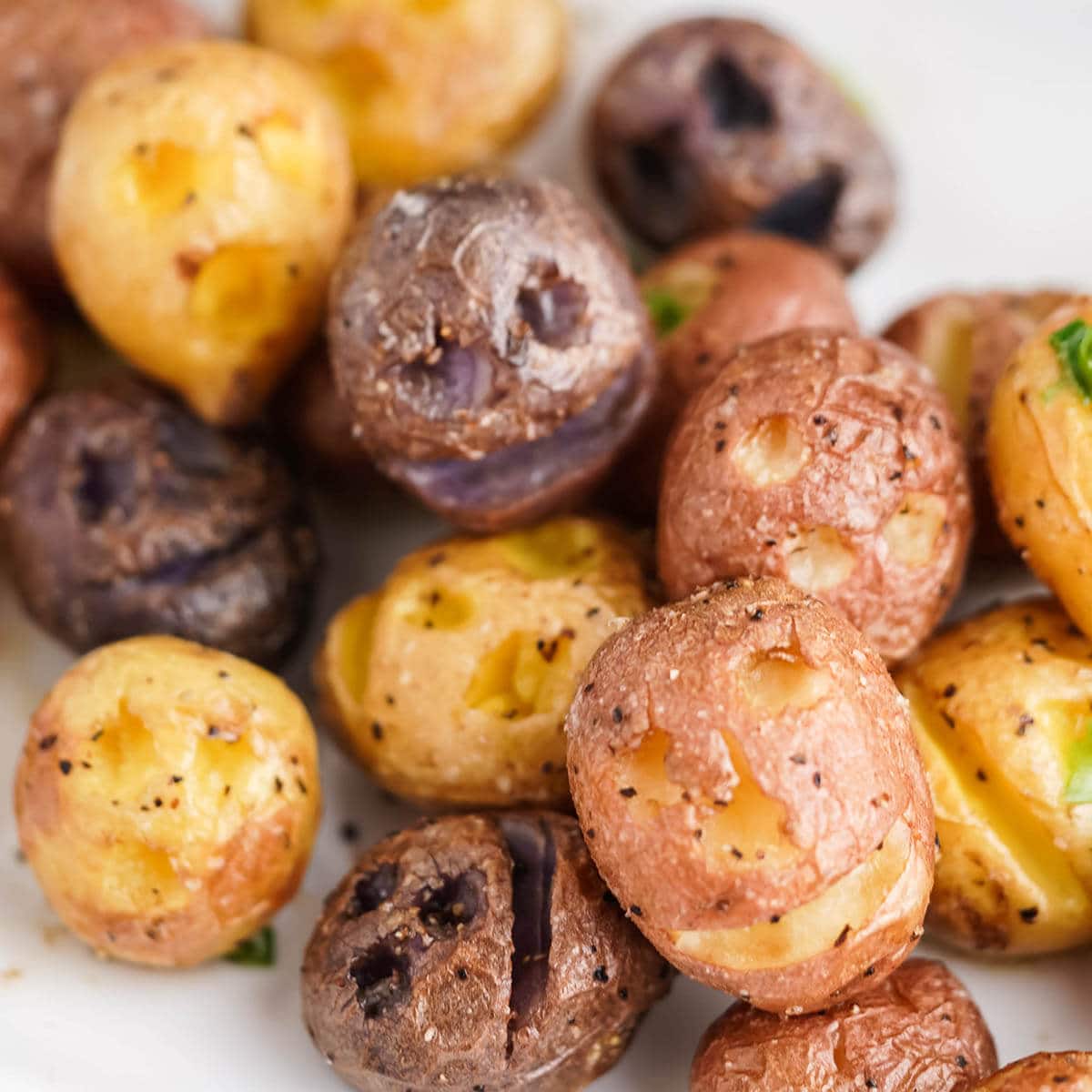 Roasted shrunken head potatoes on platter.