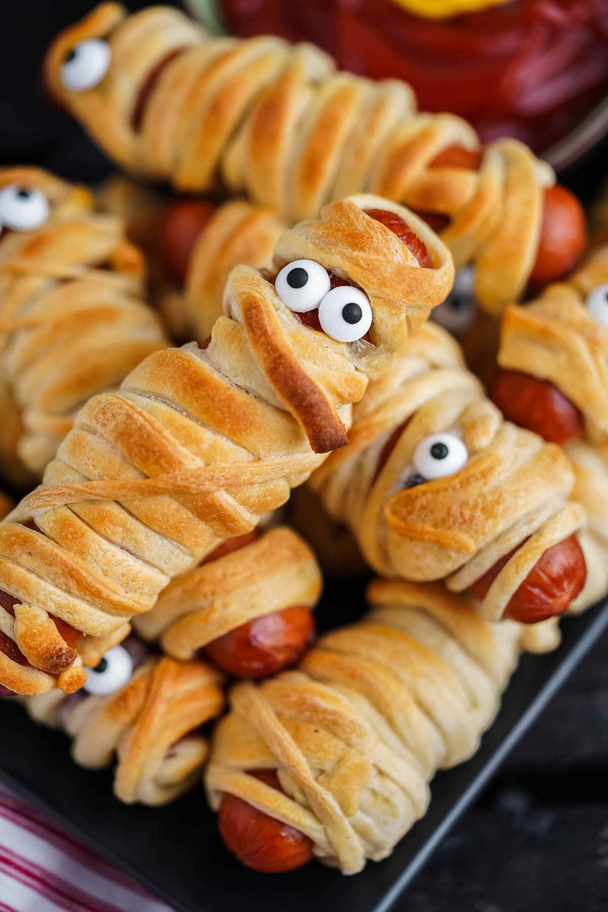 Mummy hot dogs on platter.