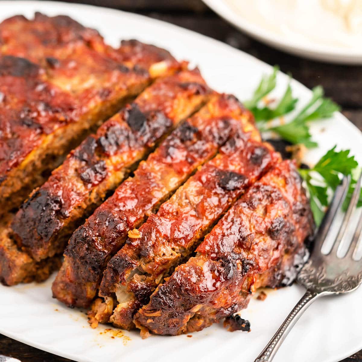 Sliced meatloaf on platter.