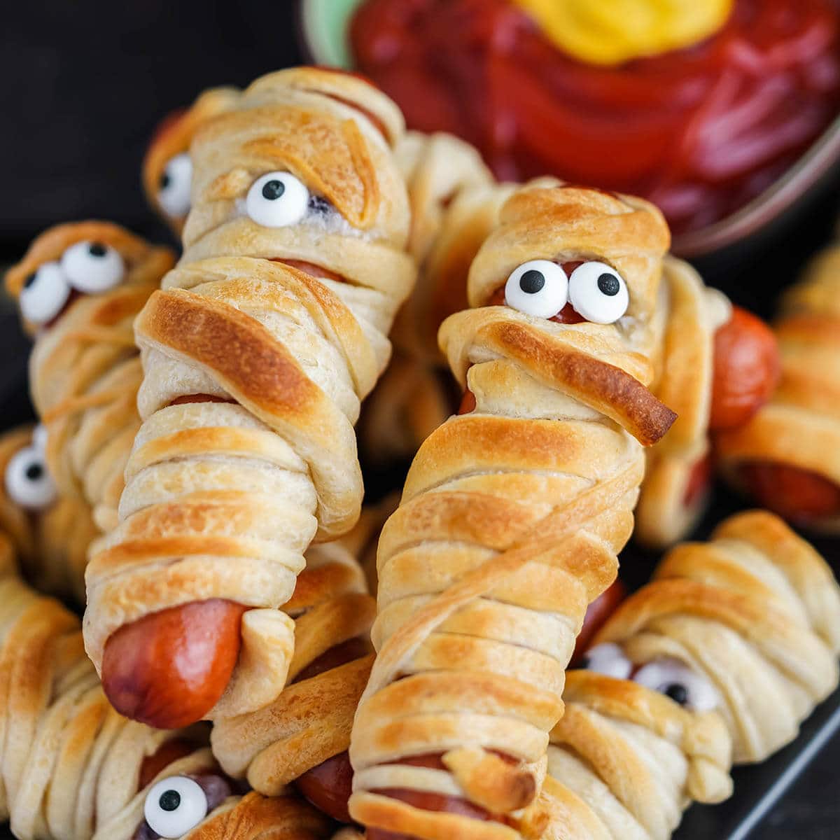 Hot dogs wrapped in crescent rolls on platter.