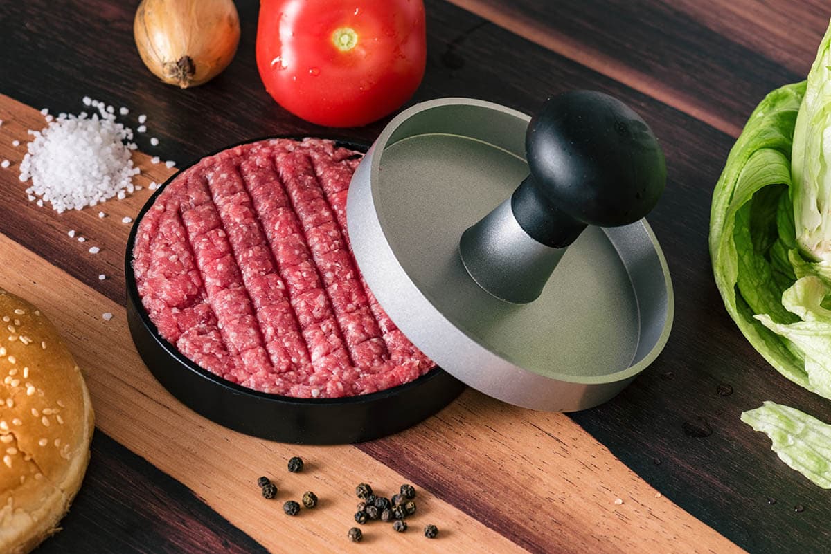 Ground beef in burger press.