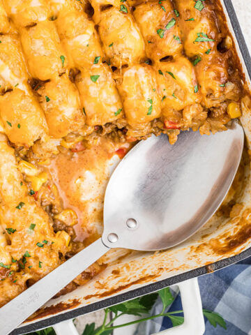 Cheesy Mexican Tater Tot Casserole in dish with spoon.