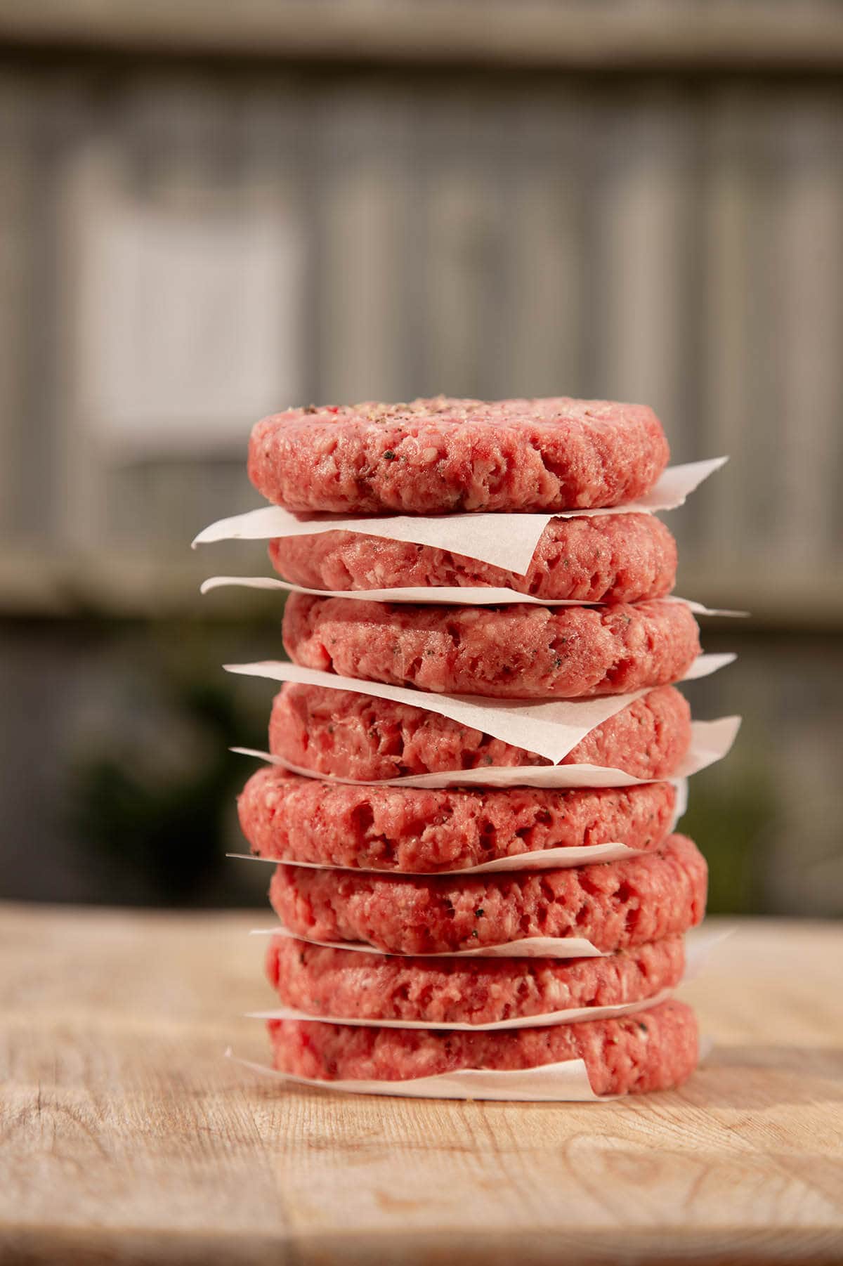 Stack of raw hamburger patties.