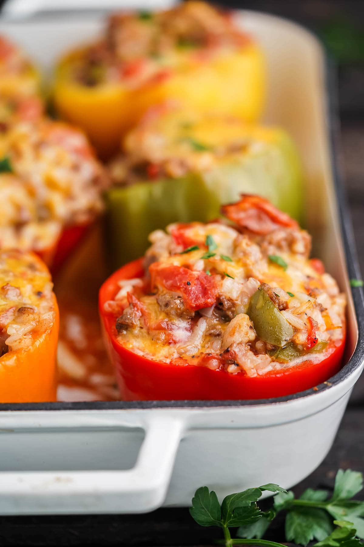 Stuffed bell peppers in baking dish.