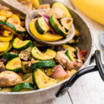 Roasted vegetables in pan with wooden spoon.