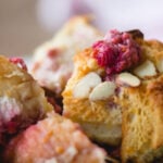 Raspberry breakfast casserole on plate. With print overlay for Pinterest.