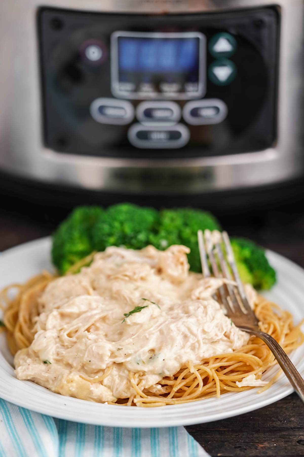 Creamy Italian Shredded Chicken over spaghetti with crockpot.