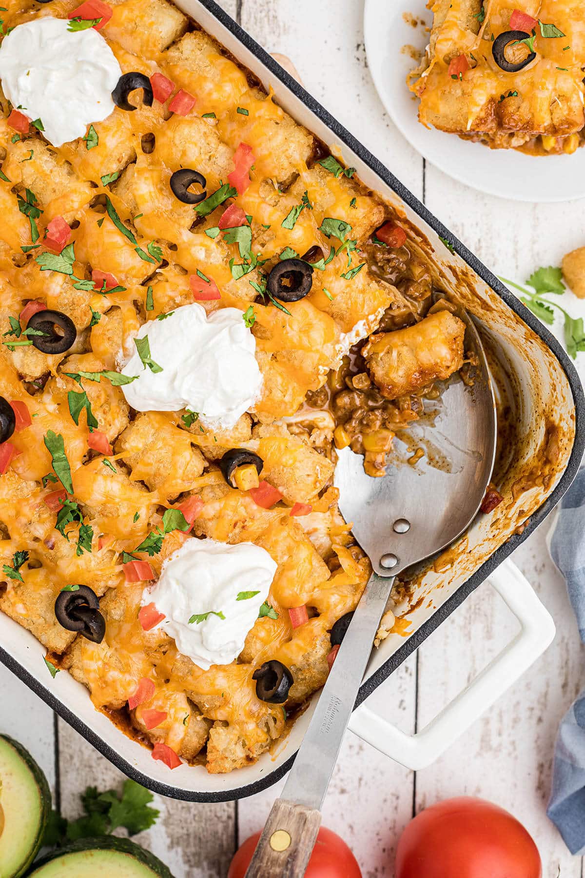 Tater Tot Casserole in baking dish with serving spoon.