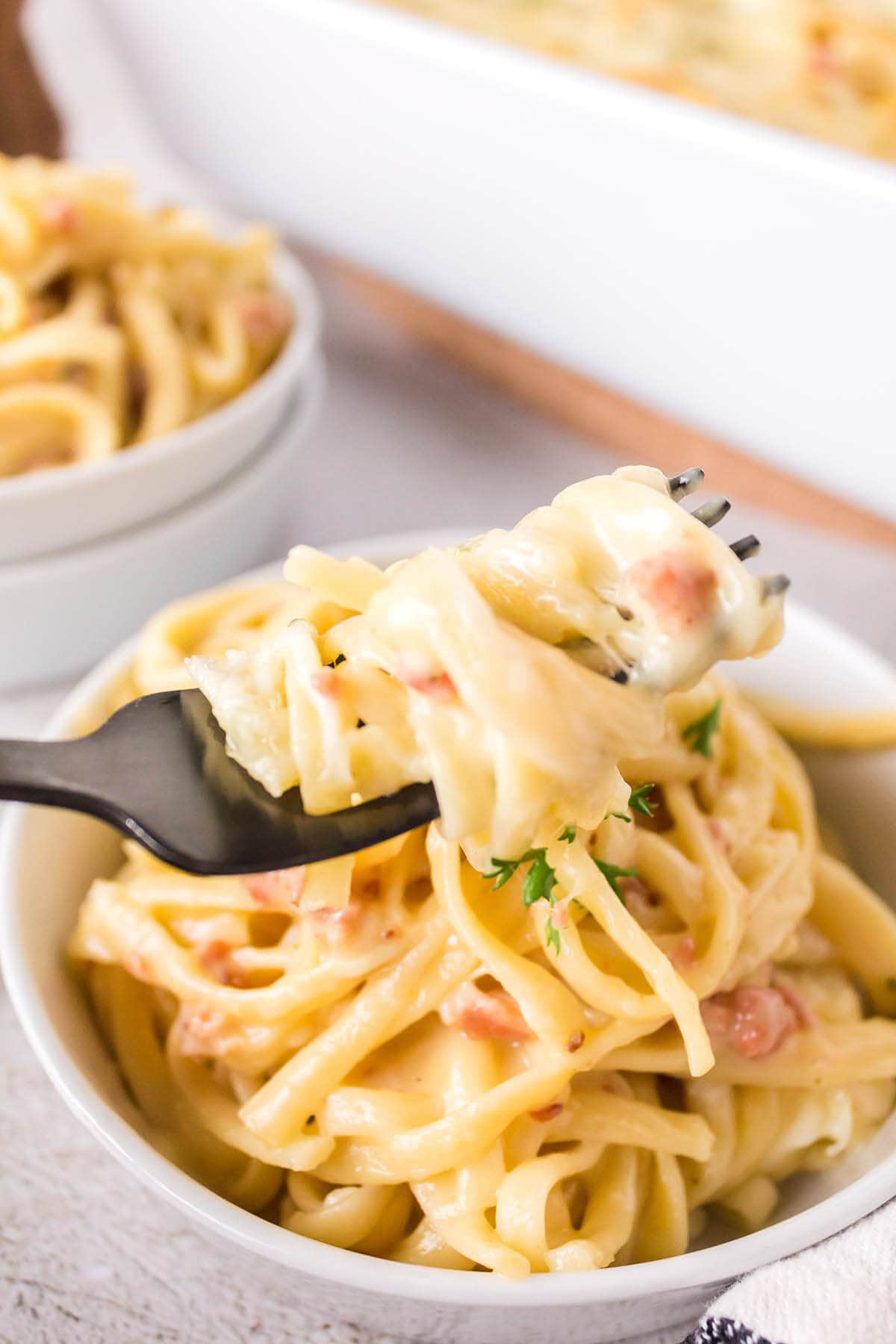 Cheesy Pasta Bake in bowl with fork.