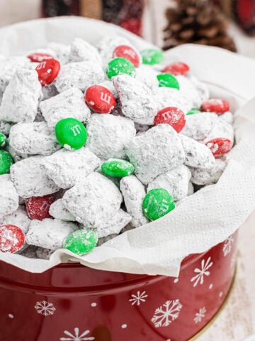 Holiday Muddy Buddies in tin with red and green m&m's.