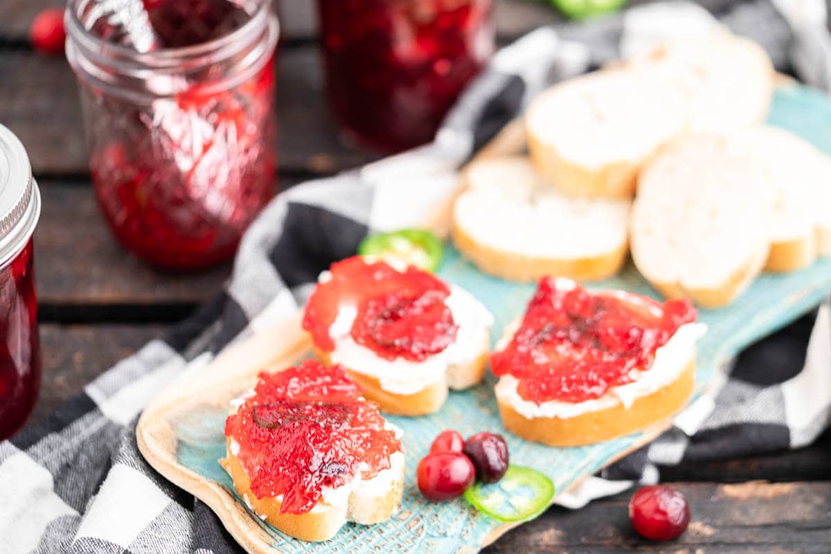 Appetizers on tray topped with cream cheese and jelly.