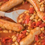 Hairy Biker Sausage Casserole in baking dish with spoon.