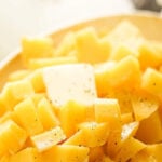 Buttered Rutabagas in a casserole dish. With print overlay for Pinterest.