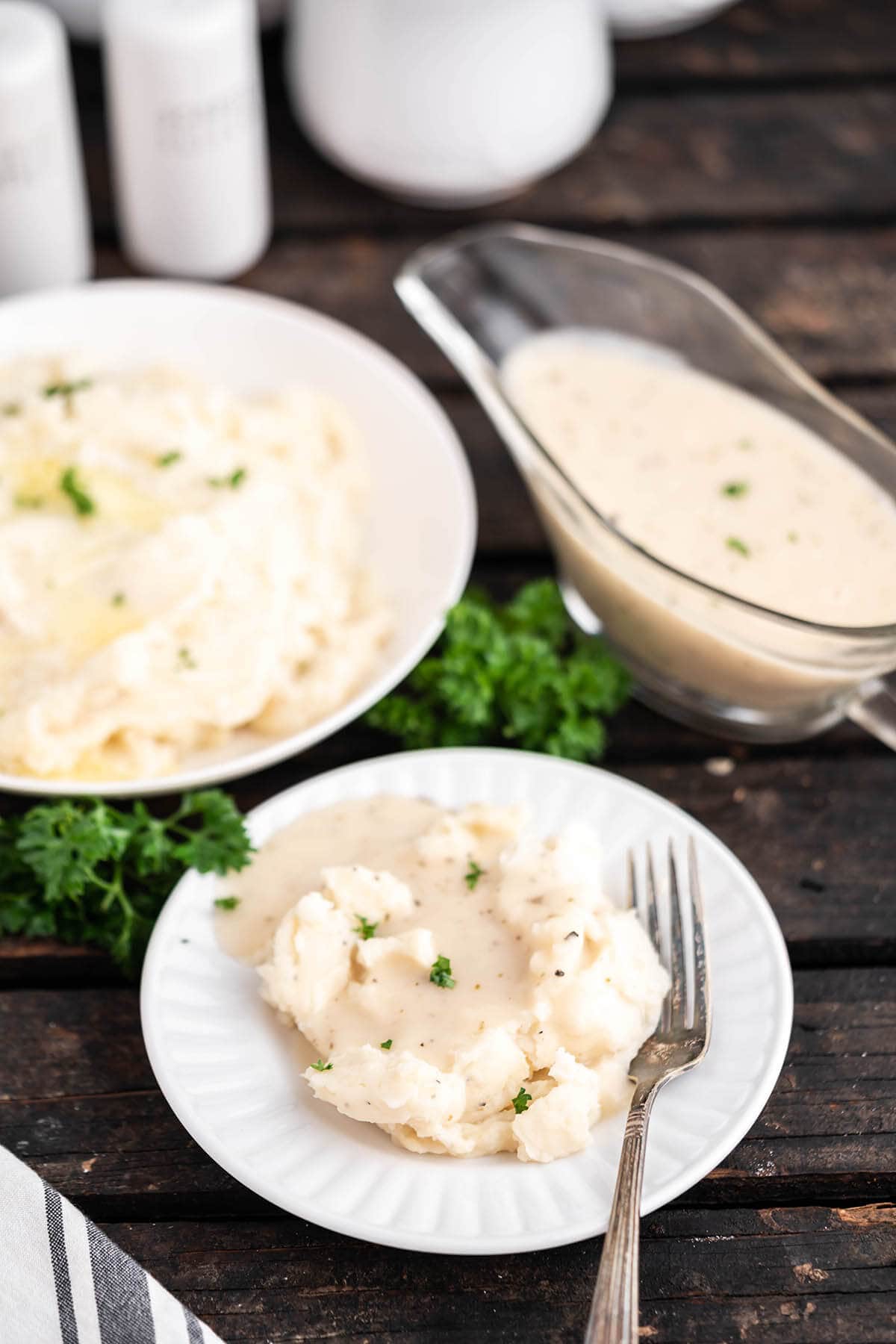 Potatoes on plate with white gravy.