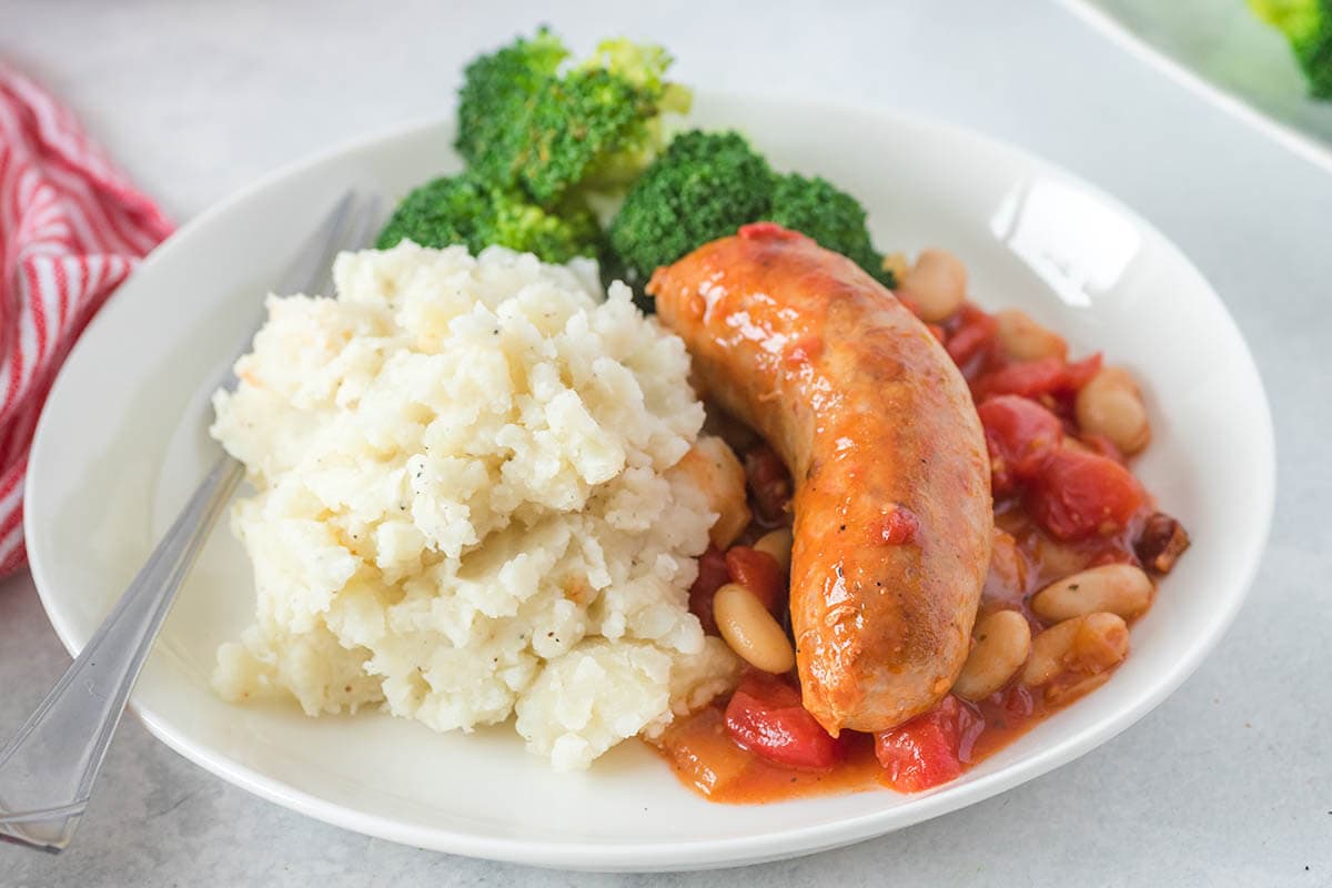 Hairy Biker Sausage Casserole on plate served with mashed potatoes.