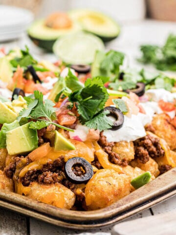 Taco Nachos on platter piled high with all the fixings.