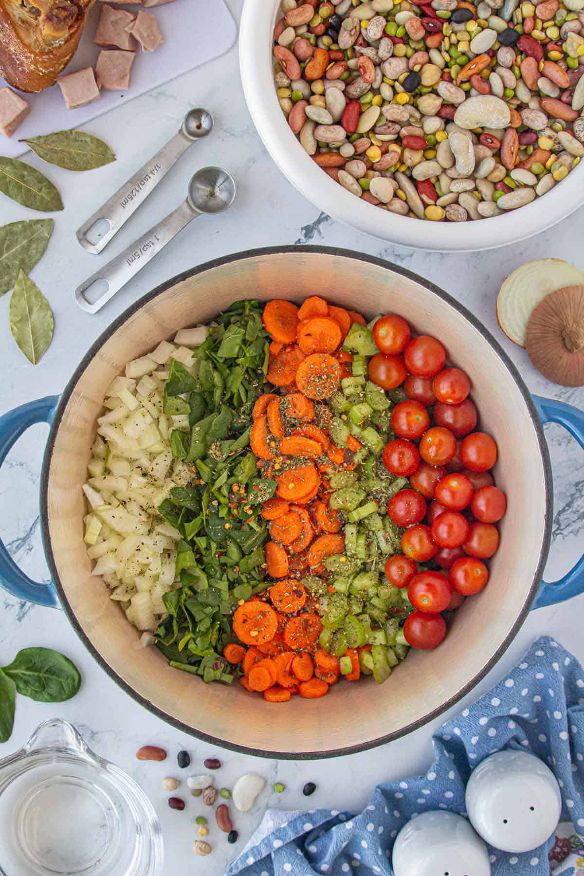 Vegetables in a stockpot seasoned with spices.