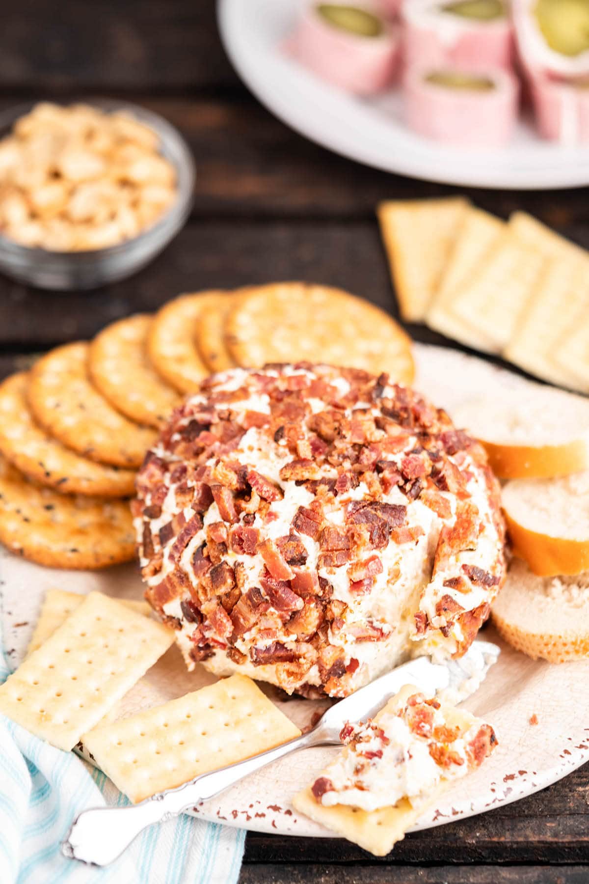 Cream cheese ball rolled in bacon with crackers.