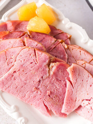 Sliced ham on platter.