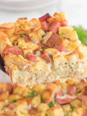 Eggs Benedict Casserole with serving spoon.
