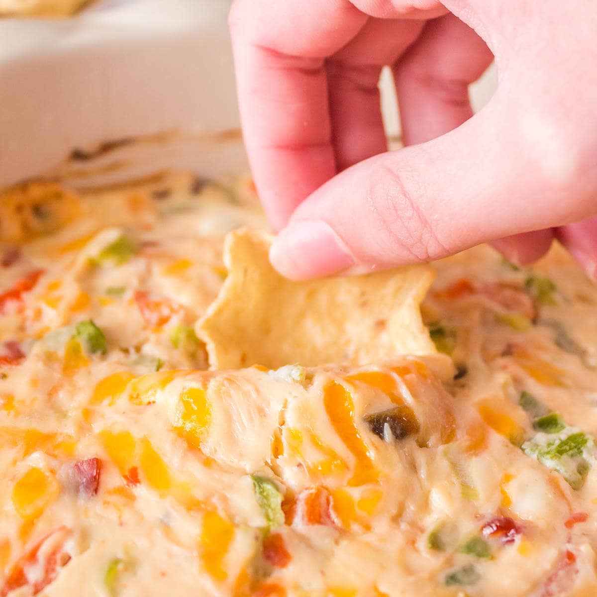 Hot Quesadilla Dip with chip for dipping.