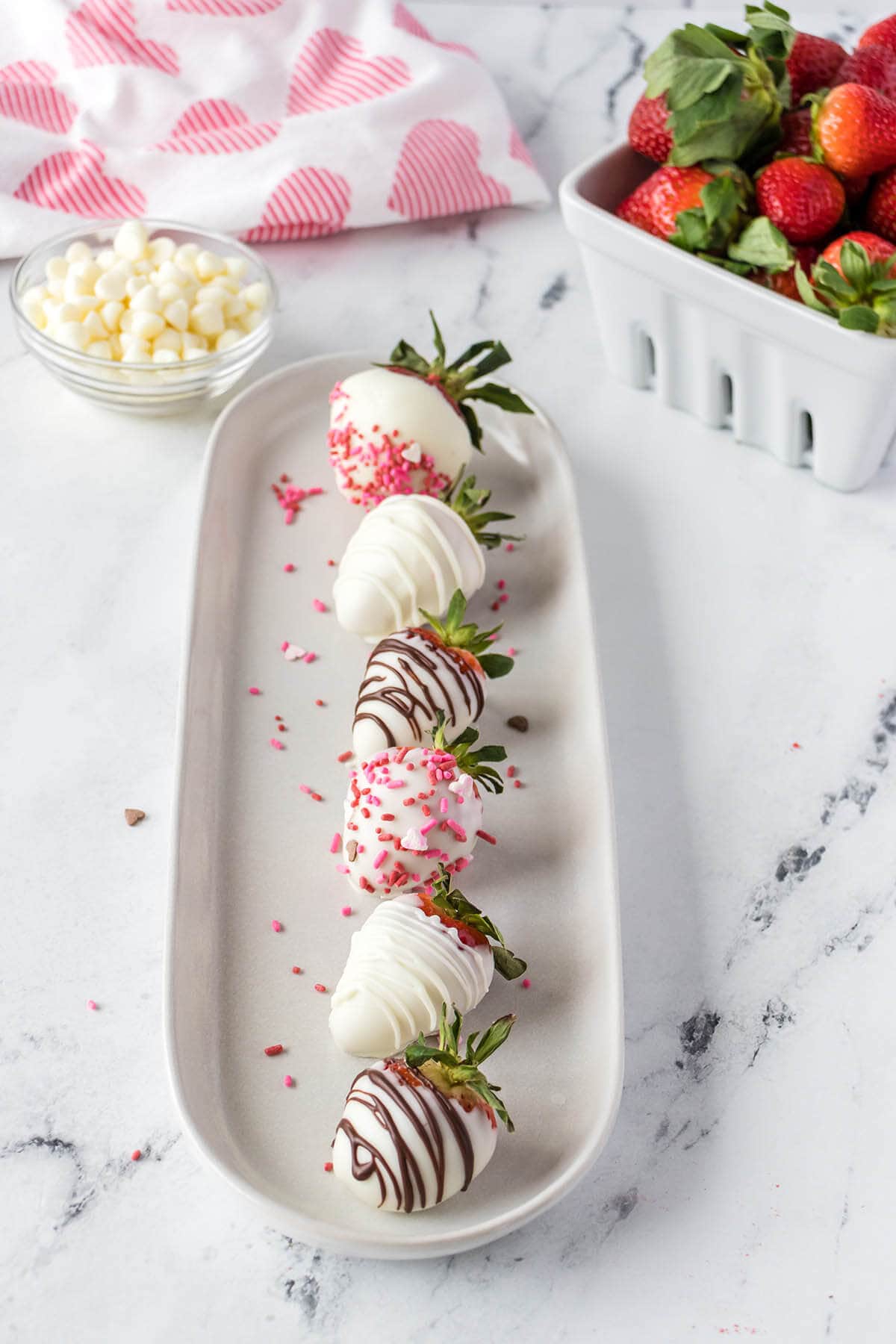 Chocolate-covered strawberries on platter.