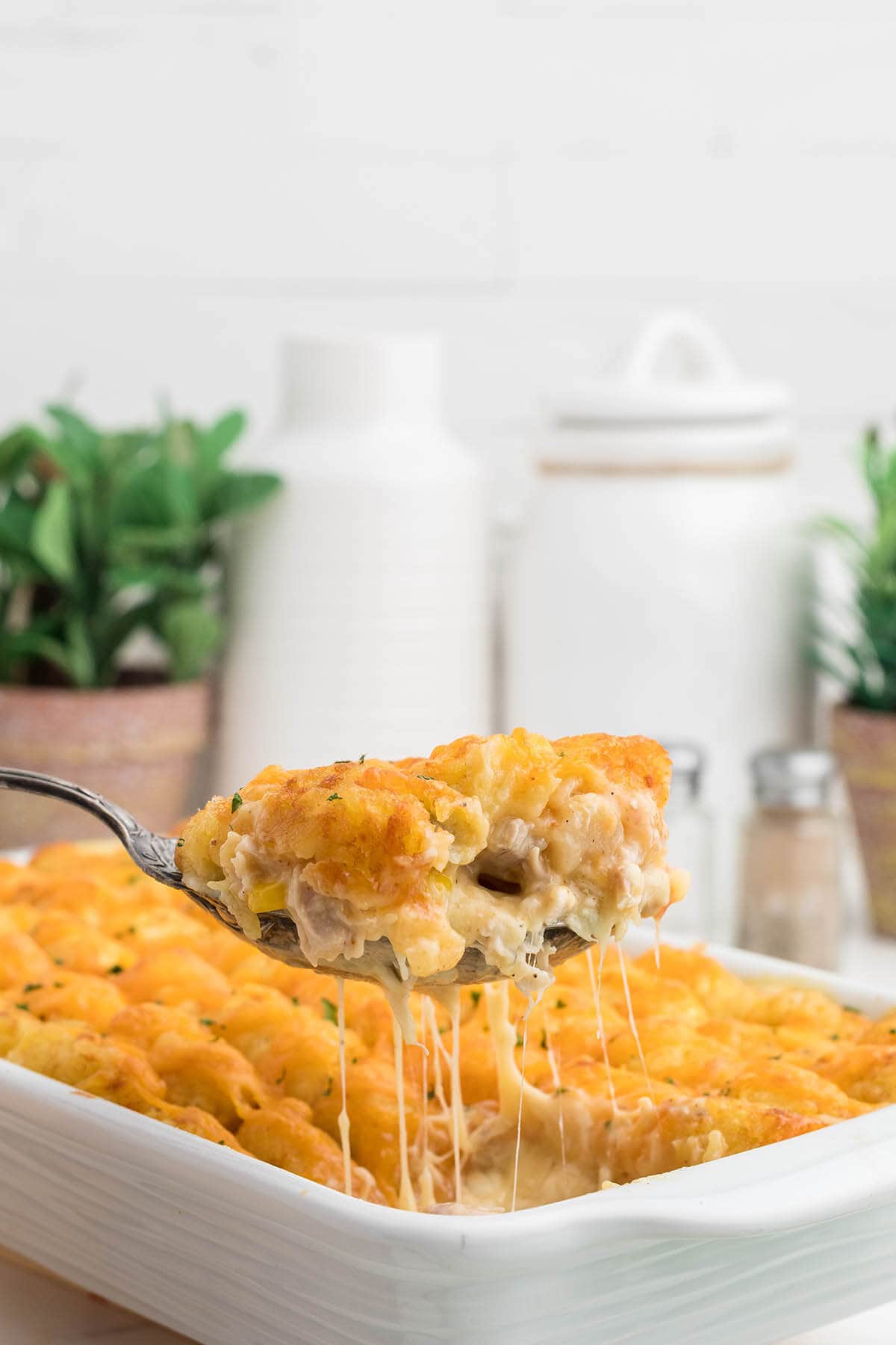 Casserole in baking dish with a serving spoon.