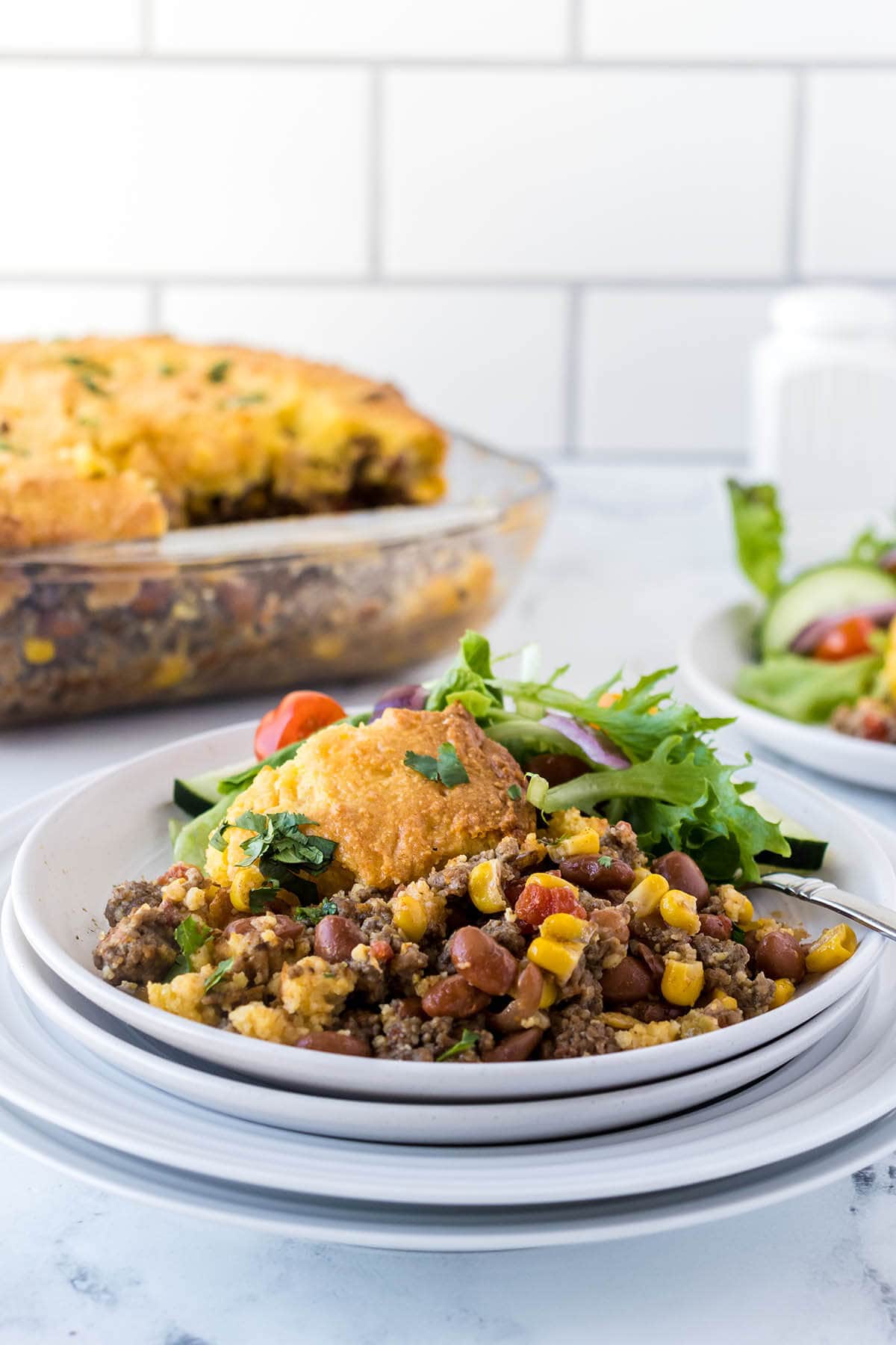 Cornbread casserole on plate with fork.