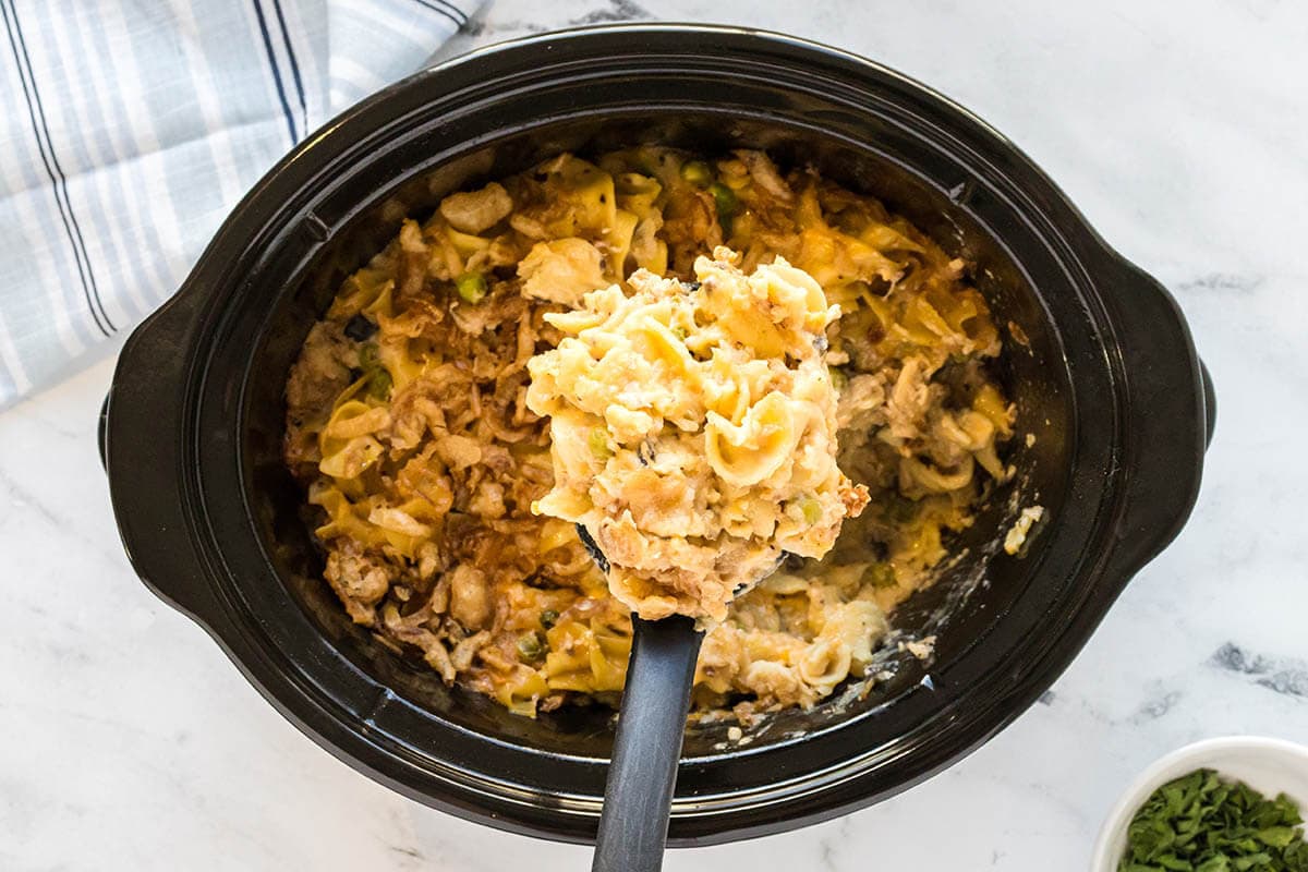 Crockpot Tuna Casserole in slow cooker with serving spoon.