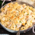 Cheesy pasta in pan with serving spoon.