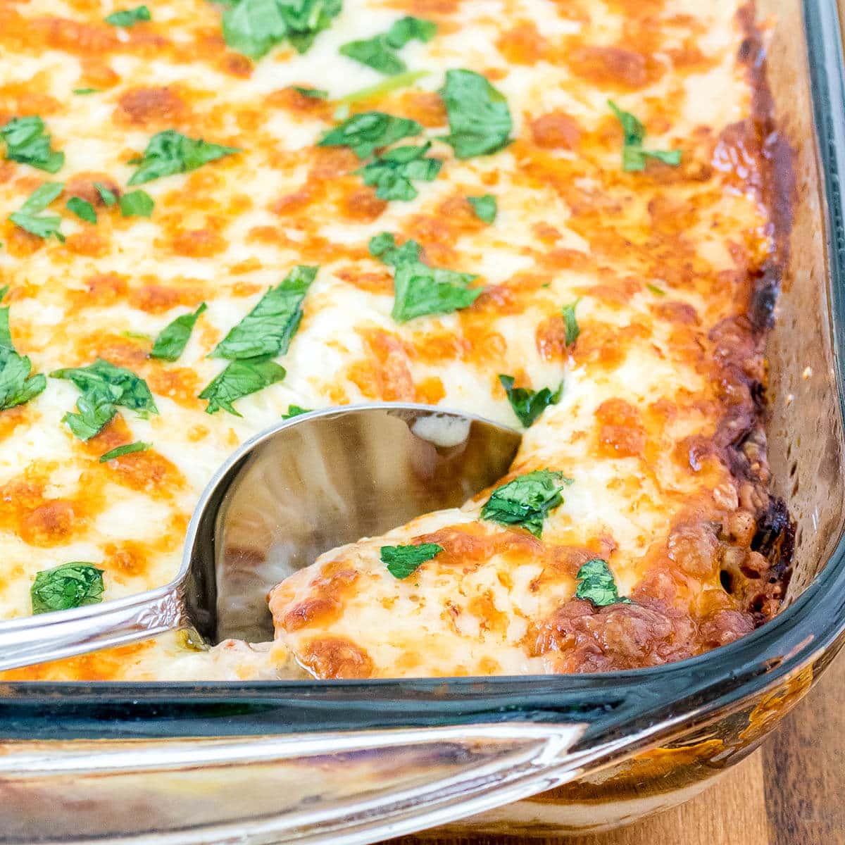 Casserole in baking dish with serving spoon.