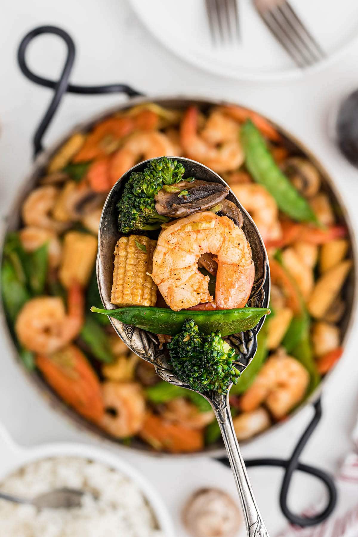 Shrimp chop suey in pan with serving spoon.