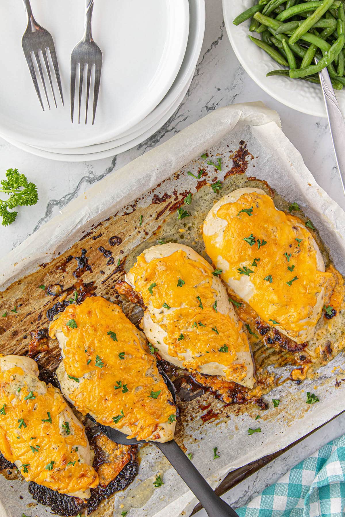 Cheesy Ranch Chicken on platter with serving spatula.