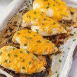 Baked cheesy chicken on sheet pan.