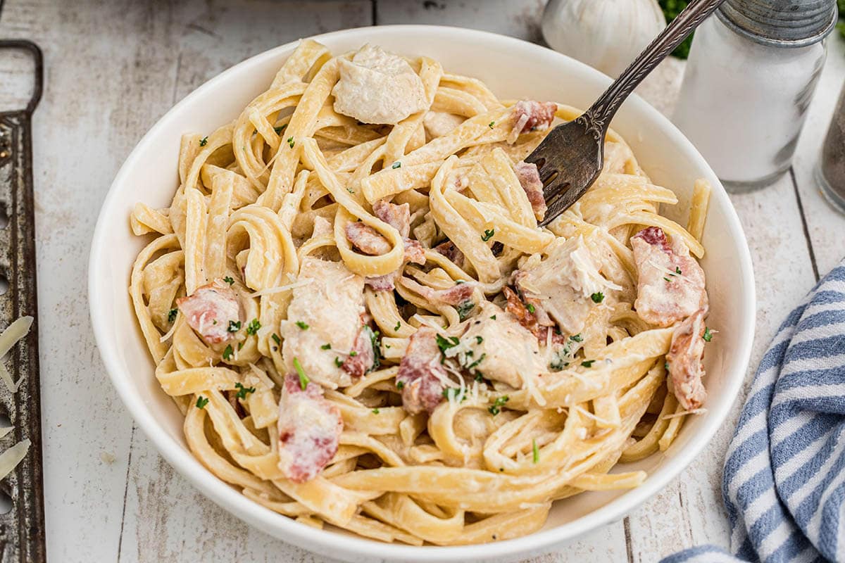 Bowl of Chicken and Bacon Pasta with fork.