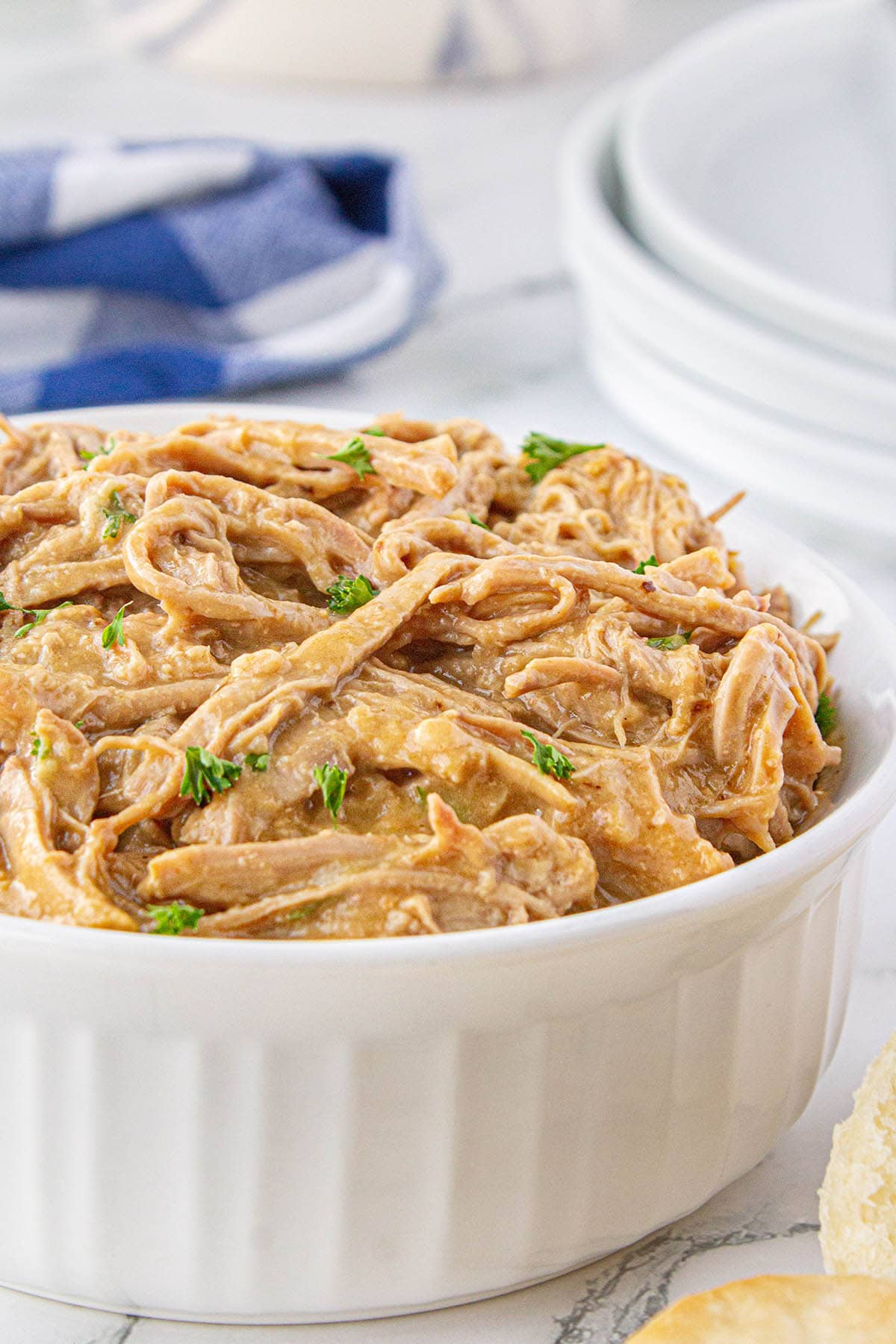 Slow Cooker pork tenderloin and gravy shredded and in a large bowl.