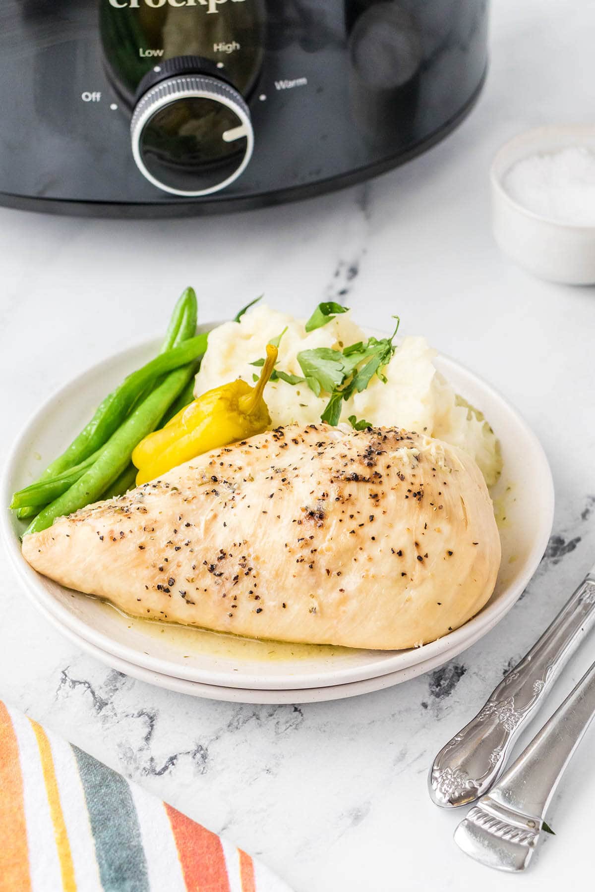 Crockpot Mississippi on plate with potatoes.