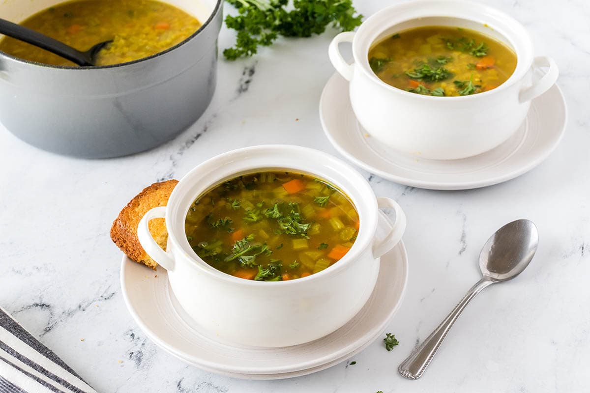 Bowls of soup on table with spoon.