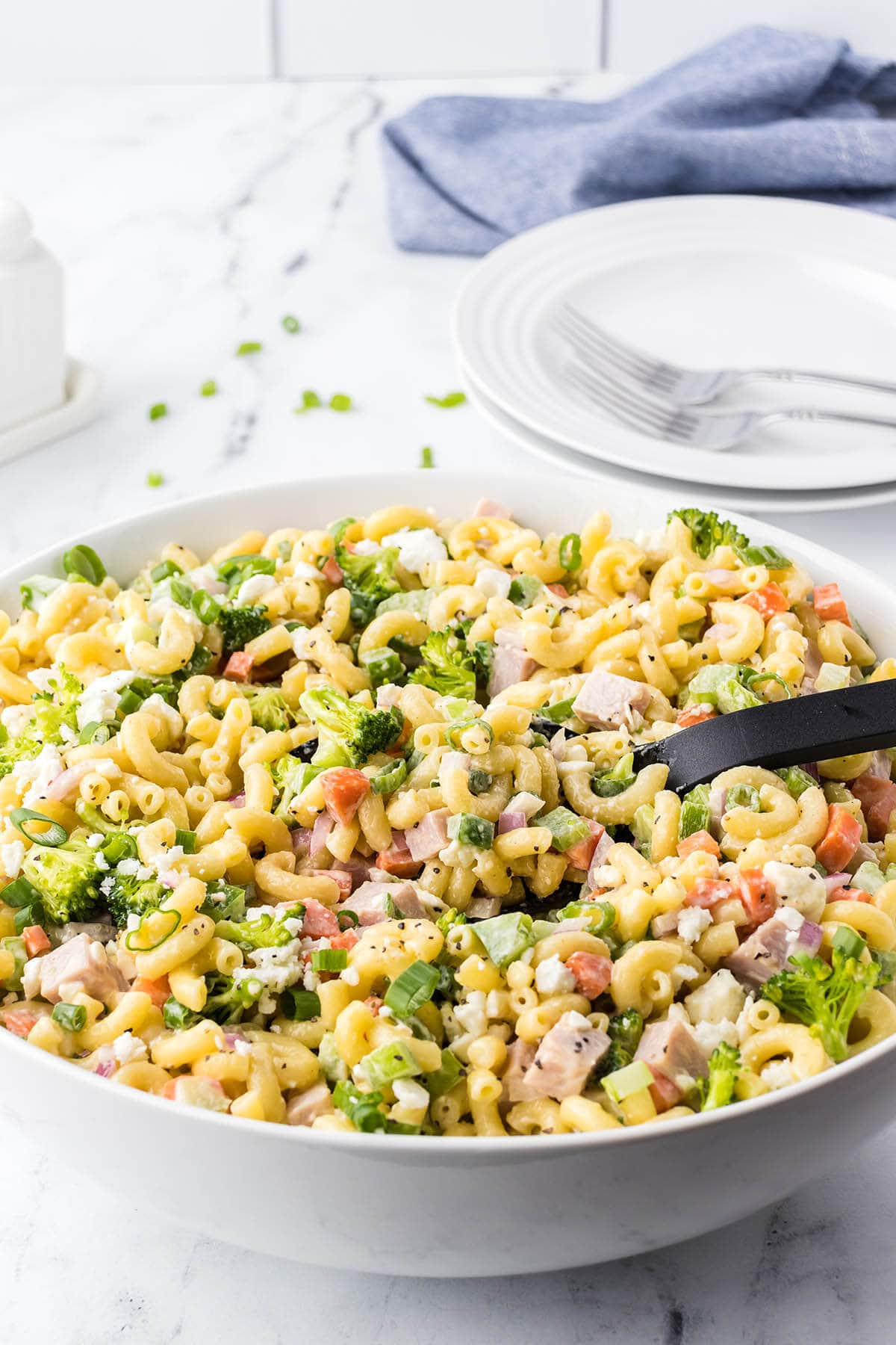 Southern Ham Pasta Salad in bowl iwht serving spoon.