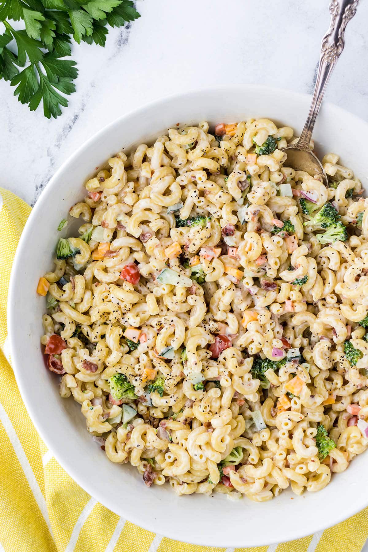 Vegetable Macaroni Salad in bowl with serving spoon.