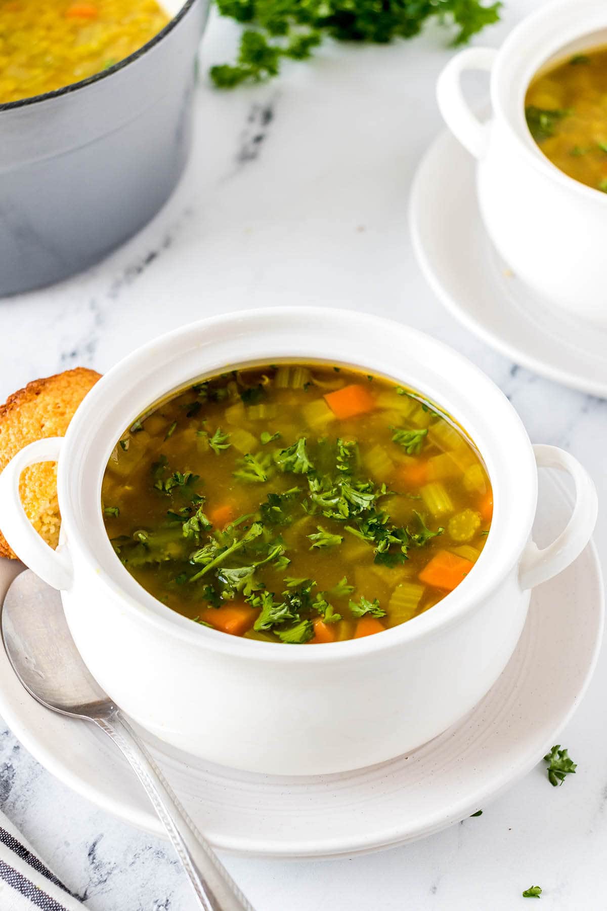 Mediterranean Lentil Soup in bowl with spoon.