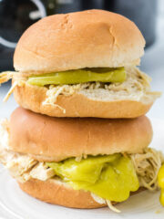 Stack of chicken sandwiches on plate.