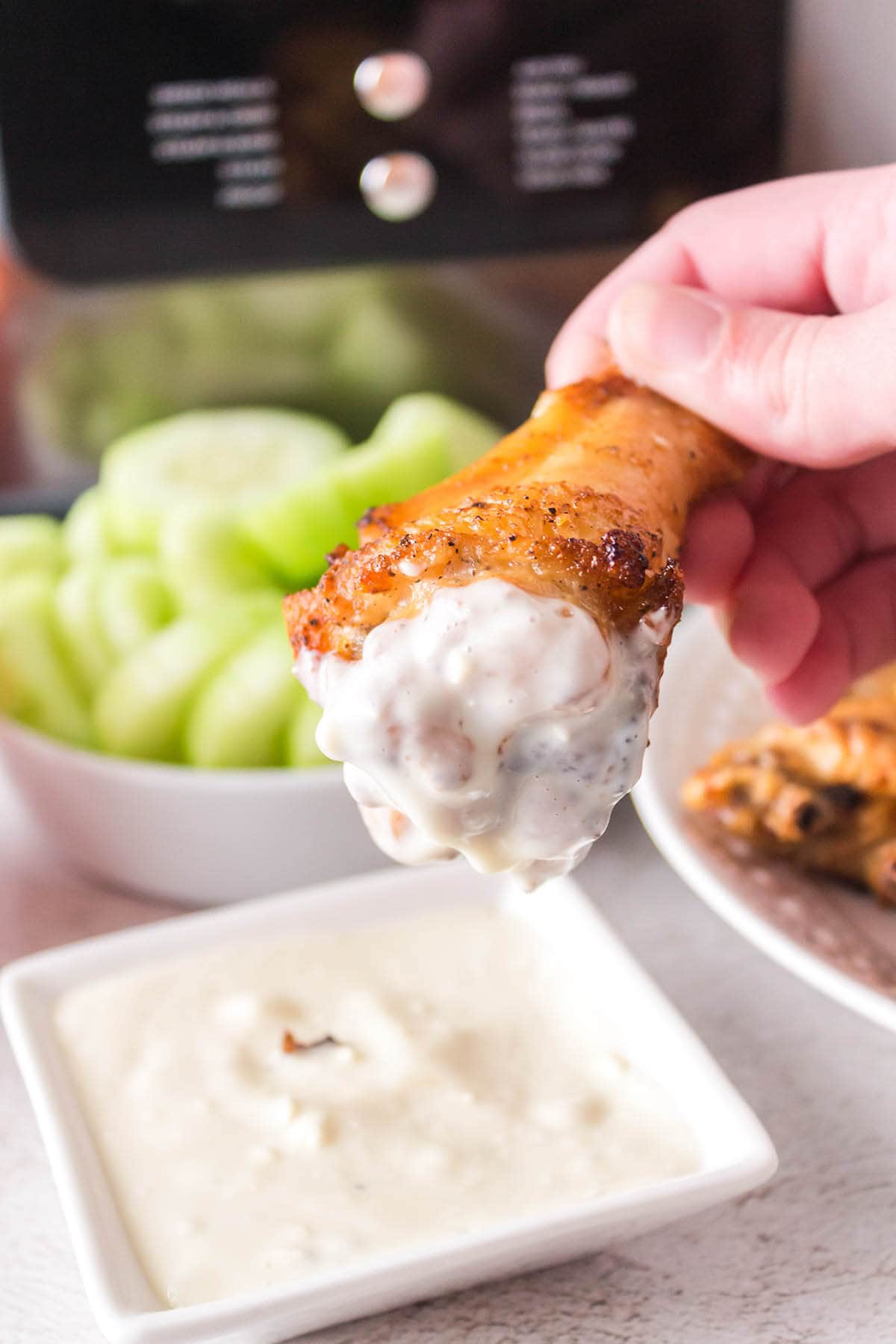 Chicken wing dipped in blue cheese dressing.