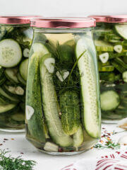Three jars of canned refrigerator dill pickles.