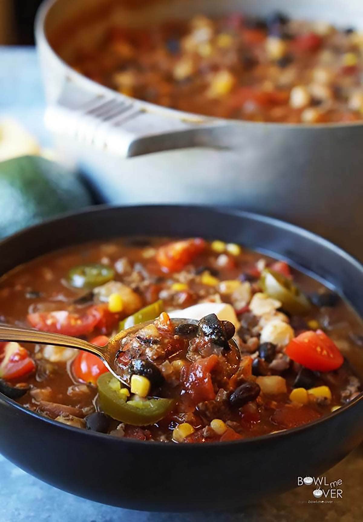 Bowl of taco soup with serving spoon.